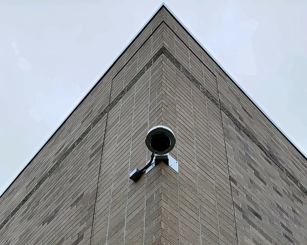 Exterior camera mounted on the corner of a brick building
