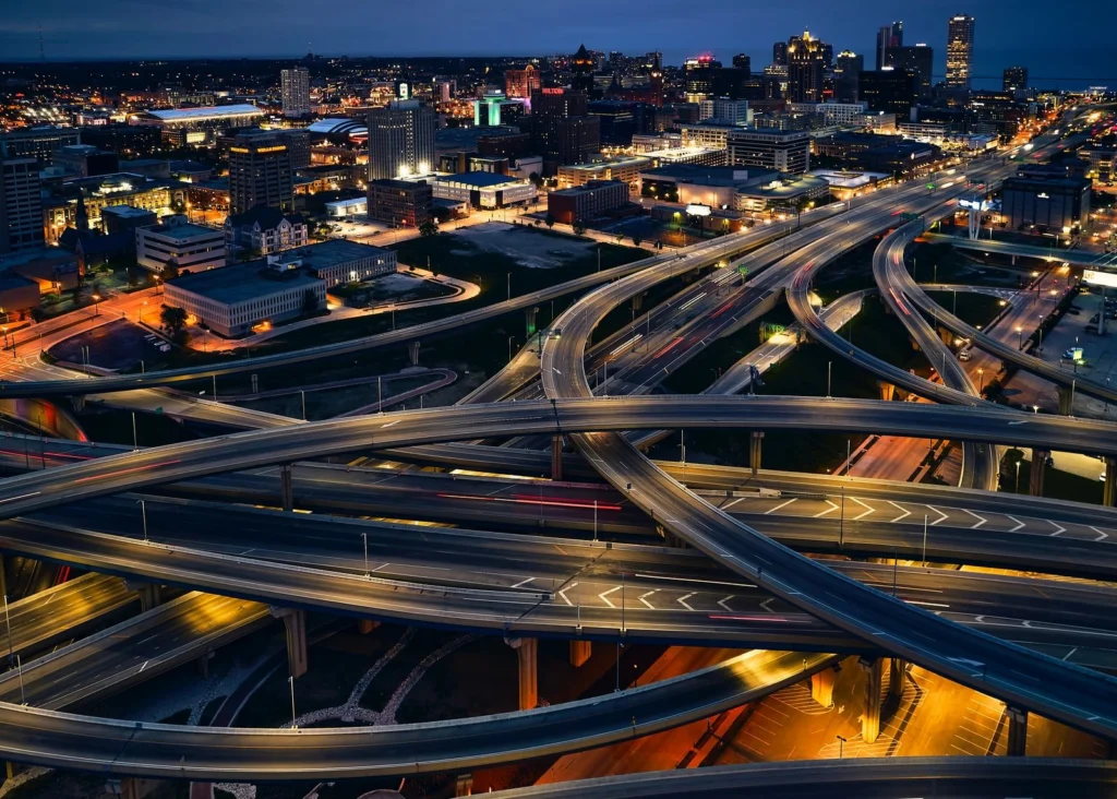 Milwaukee area highway interchange and skyline at night