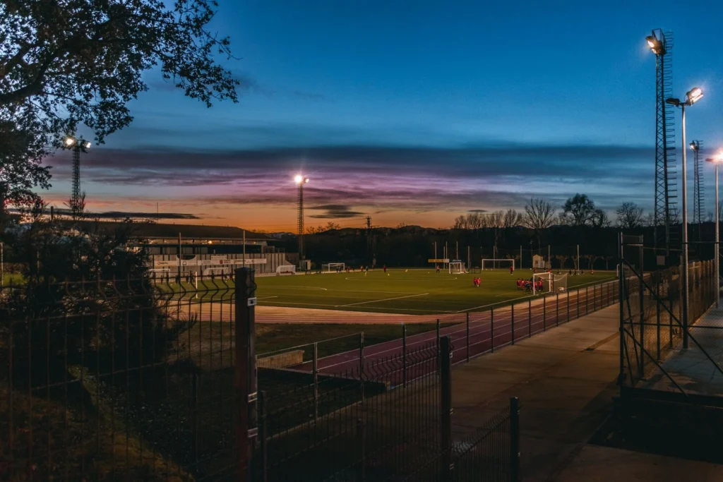 Athletic field under lights at dusk