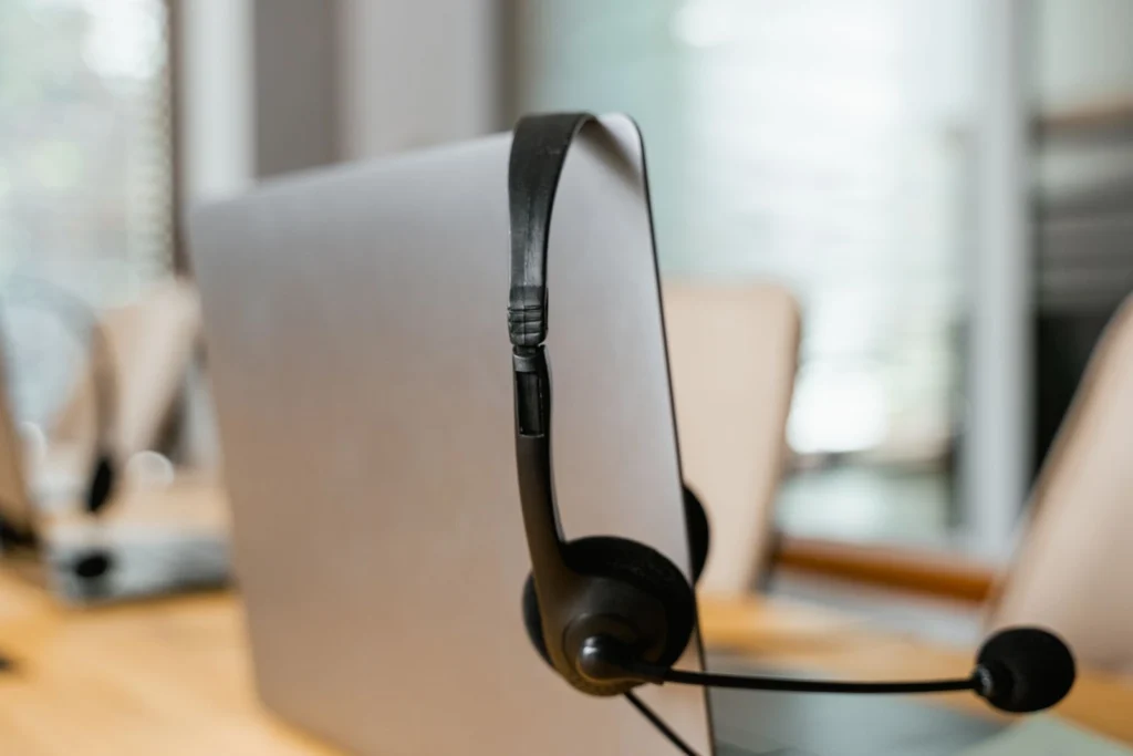 Headset hanging on a monitor at a support desk